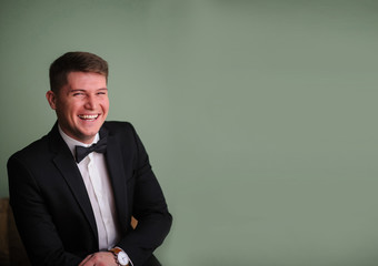 Handsome brunette groom laughing on the camera © Med Photo Studio