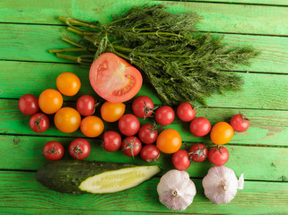 Vegetables on green wooden background.