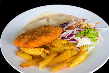 Schnitzel cutlet with potato and salad. Fried chicken cutlet top view photo on wooden table