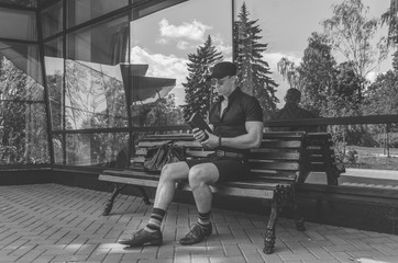 Obraz premium a student in a shirt and glasses reading a book in the city Park