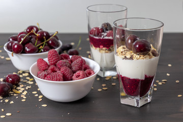 yoghurt with probiotic in a glass beaker with fruit on a dark wooden table