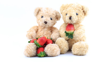 Brown bear and strawberry on a white background.