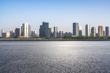 empty asphalt road with modern office building in urban