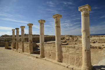 Fototapeta premium Row of ancient columns against blue sky background