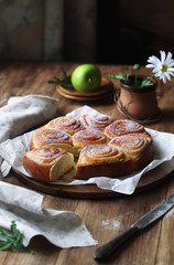 Sweet Rolls with Vanilla Pastry Cream, powdered with icing sugar, on wooden table.
 