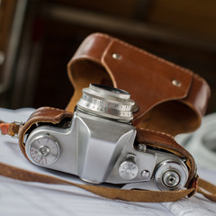 old film camera lies on the documents.
