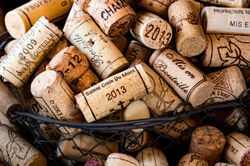 old cork stoppers of French wines in a wire basket