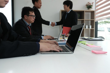 Business people shaking hands after finishing up meeting. Two colleagues handshaking after conference. Greeting deal, teamwork, partnership, corporate concept.