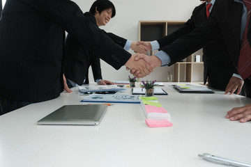 Business people shaking hands after finishing up meeting. Two colleagues handshaking after conference. Greeting deal, teamwork, partnership, corporate concept.