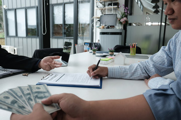 client signing contract with realtor at real estate agency. property, finance & banking concept