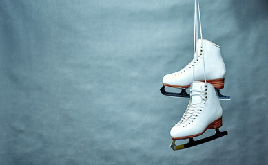 Women's skates with laces on a gray background. - obrazy, fototapety, plakaty