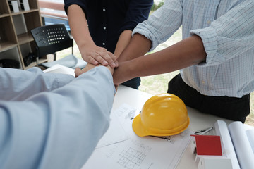 architect & customer joining hands. Engineer put hand together with partner for successful deal in building project development. business teamwork concept
