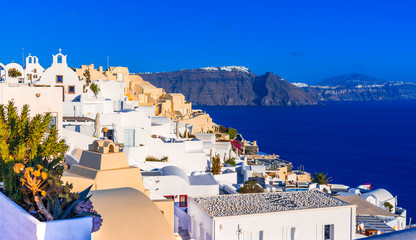 Oia town, Santorini island, Greece: Traditional and famous white houses and churches over the...