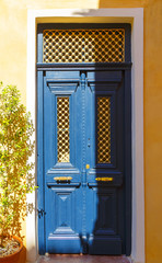 Old doors blue wood with evening soft sunlight of Greek island Crete