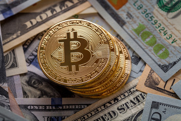 golden bitcoin coin on us dollars close up. Electronic crypto currency