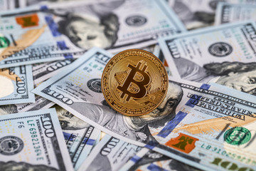 golden bitcoin coin on us dollars close up. Electronic crypto currency