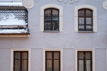 Snow falling with windows, building on the background.