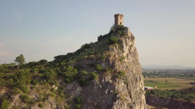 Piccola torre di un castello medievale su una rupe scoscesa. Torre di Caprona in provincia di Pisa. Vista aerea.