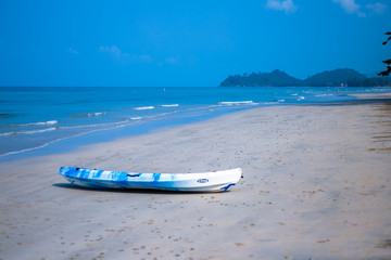 Sea coast, beach, clear turquoise sea water, boat on the sand 