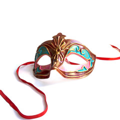 Red and gold carnival mask with satin ribbons.