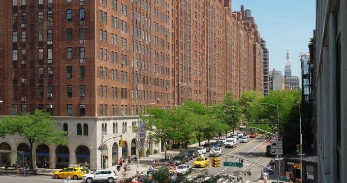 A daytime high angle establishing shot view of traffic along 10th Avenue in midtown Manhattan.  	