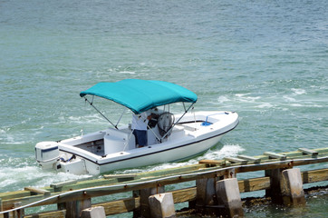 florida Intra-Coastal Waterway near floridSmall runabout motorboat with light blue canvas canopy on the on the Florida Intra-coastal Waterway near Miami Beach. © richard pross