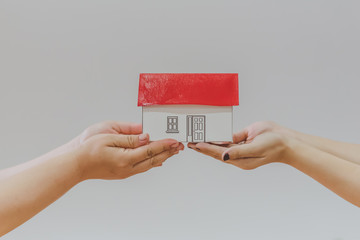 Selling real estate concept with a house and key