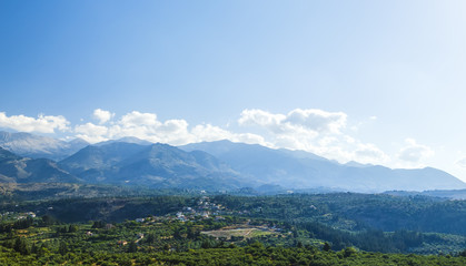 Countryside. View of the valley, village and mountains in the distance on a cloudy evening Greece, island Crete .