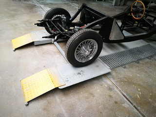 Chromspeichenrad mit Schnellverschluss am nackten Chassis eines englischen Roadster der...