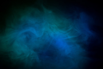Fototapeta na wymiar blue smoke on a black background