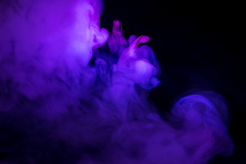 Fototapeta na wymiar purple smoke on a black background
