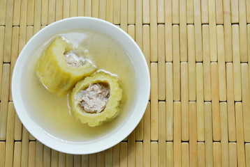 boiled bitter melon stuffed minced pork and glass noodles soup on bowl