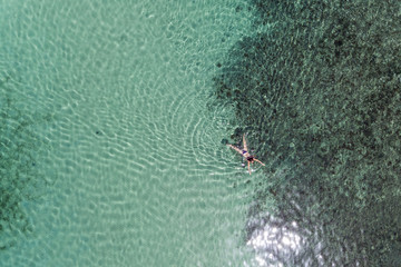 Aerial view of a girl swimming in the sea