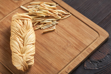 Smoked braided cheese on a wood background