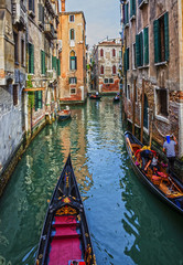 Fototapeta na wymiar Gondolas in Venice canal, narrow street, Italy