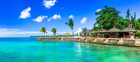 Luxury vacation in tropical resort. Mauritius island. Beachside restaurant - obrazy, fototapety, plakaty