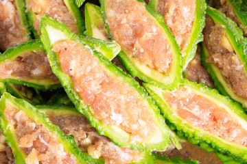 Close up bitter gourd pile with stuffed hack pork and garlic black pepper ingredient. vegetable herb Nourish the health body. Thai food
