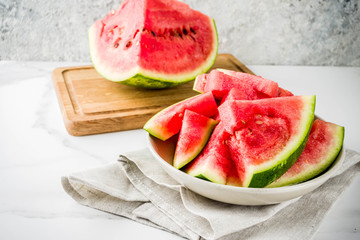 Fresh raw sliced watermelon on light concrete table copy space