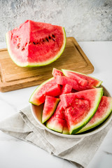 Fresh raw sliced watermelon on light concrete table copy space