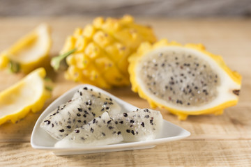 yellow pitahaya dragon fruit on wooden background