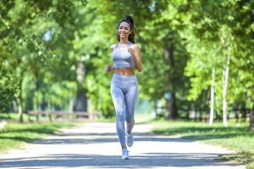 Young fit beautiful girl running outdoor