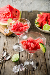 Sweet summer watermelon and lime granita with sliced watermelon and mint, on white marble background copy space