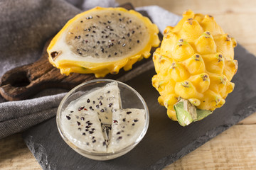 yellow pitahaya dragon fruit on wooden background