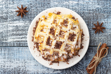 Homemade waffles with chocolate and powdered sugar. Top view.