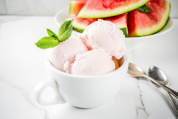 Sweet homemade Watermelon ice cream served with mint, white marble background copy space