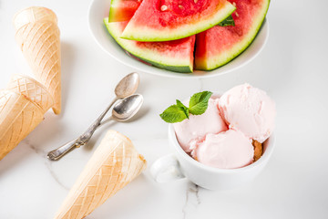 Sweet homemade Watermelon ice cream served with mint, white marble background copy space