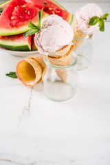 Sweet homemade Watermelon ice cream served with mint, white marble background copy space