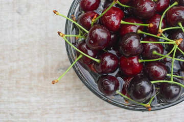 Spelled cherries on the white wooden background