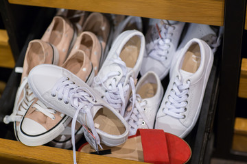 Shoes for sale at shop- Pile of assorted footwear in mall