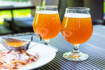 Two glasses of beer and meat snacks